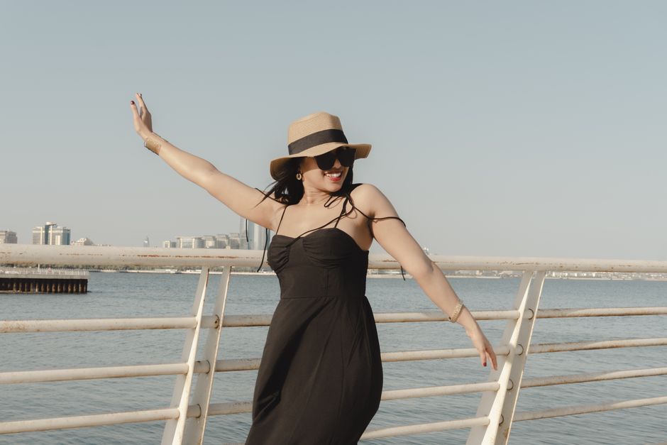 Fashionable woman in Baku, Azerbaijan enjoying the outdoors with a summer hat.