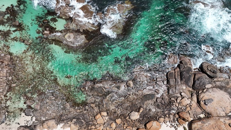 Breathtaking aerial shot of rocky coastline and turquoise waters in Western Australia.