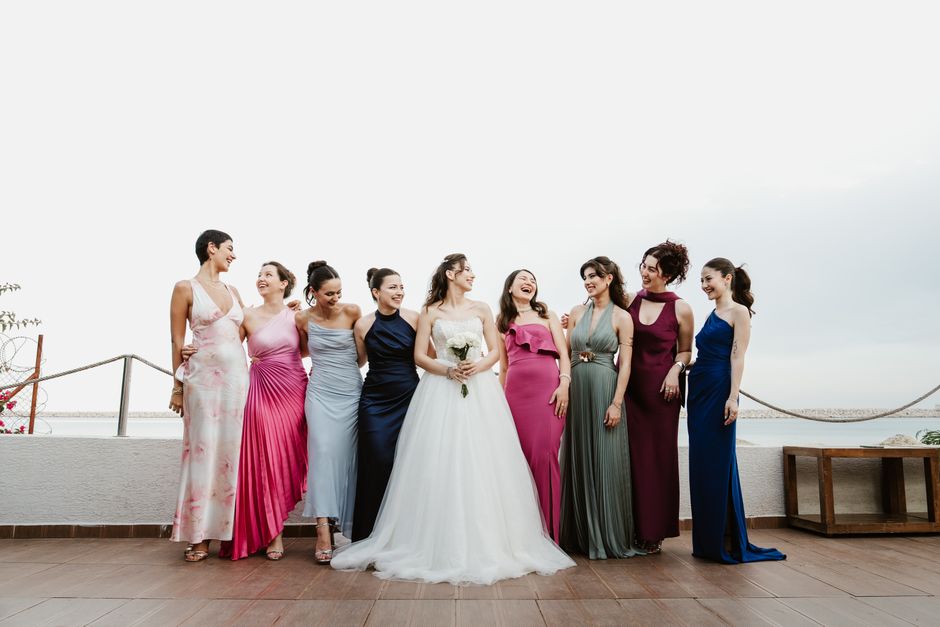 Bride and bridesmaids laughing together outdoors in Antalya, Türkiye.