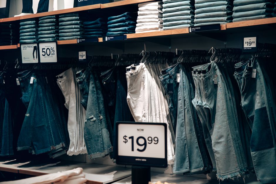 Explore a stylish denim collection at a boutique in Miami, showcasing jeans with discounts.
